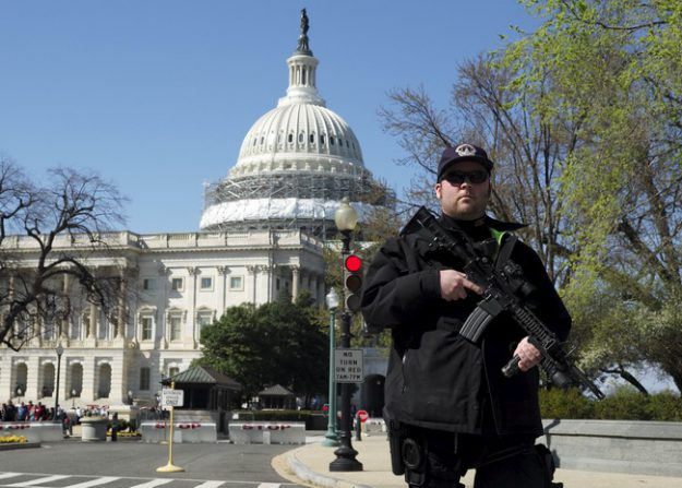 A U.S. Capitol police officer guards the perimeter in front of the U.S. Capitol Building after a shooting at the U.S. Capitol Visitors Center in Washington
