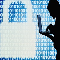 Hacker in action with laptop